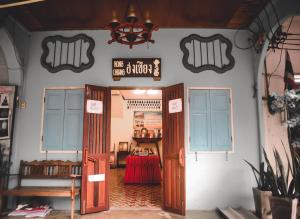 an entrance to a store with two doors and a table at Thaweesuk Heritage Homestay in Phangnga