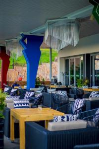 a restaurant with blue chairs and a wooden table at Onomo Hotel Kigali in Kigali