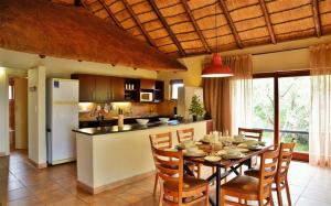a kitchen and dining room with a table and chairs at BushTime Mabula in Mabula