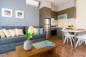 a living room with a couch and a table at Elounda Colour Apartments in Elounda