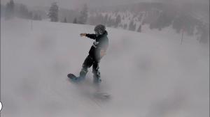 a man riding a snowboard down a snow covered slope at Ferienwohnung Haus am Bach in Toggenburg in Wildhaus