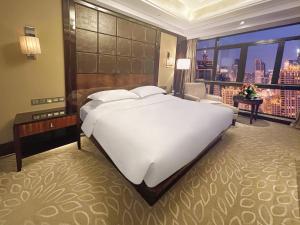 Postel nebo postele na pokoji v ubytování Lv Shou Hotel + 37 fotografií