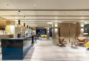 a lobby with chairs and a bar in a building at Hotel Panorama in Andorra la Vella