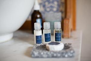 three bottles of essential oils sitting on a counter at Leipzig Country House & Winery in Nuy