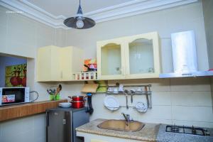 a kitchen with a sink and a counter top at Résidence Nopeli in Cotonou