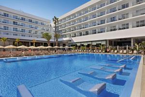 a large swimming pool in front of a hotel at Hotel Riu Playa Park - 0'0 All Inclusive in Playa de Palma