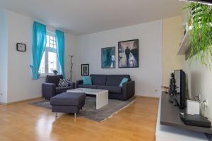 a living room with a couch and a tv at Haus Metropol 2-Raum-Apartment - Nr. 10 in Binz
