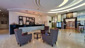a lobby with chairs and a table in a building at Swan Garden Hotel in Malacca