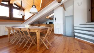 a kitchen with a wooden table and chairs at Italianway - Sertorelli 60 in Bormio