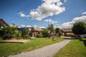 a park with a playground and a swing at FerienPark Kreischberg by ALPS RESORTS in Sankt Lorenzen ob Murau