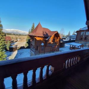 a small building with a roof on a balcony at CHALETS GREY GOOSE in Yablunytsya
