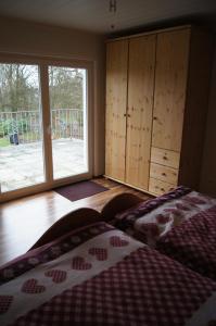 a bedroom with two beds and a large window at Ferienwohnung Bergisch Land in Wermelskirchen