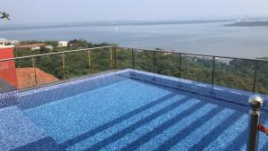 a swimming pool with a view of the water at seaview Apartment in Nārāinpur +10 photos