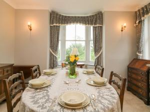 a dining room with a table and a window at Silver Crooks in Holsworthy