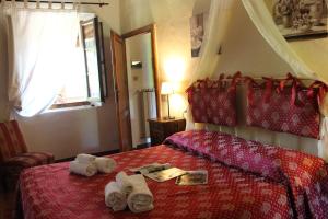a hotel room with a bed with towels on it at Borgo Santinovo in Colle di Val d'Elsa