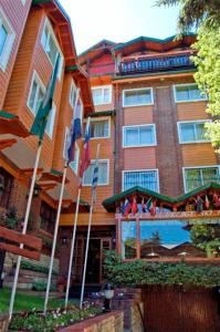 a large building with flags in front of it at Ruca Cheli Village Ski Hotel in San Carlos de Bariloche +37 photos