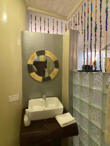 a bathroom with a mirror and a sink at Jafferji Beach Retreat, in Matemwe