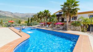 a swimming pool in front of a house at Casa Las Lomas de San Rafael Periana by Ruralidays in Periana