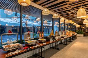 a display case in a store with a lot of food at Fleur de Lys Hotel Quy Nhon in Quy Nhon