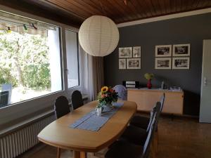 a dining room with a table and a large window at Ferienhaus Brenzblick in Gundelfingen