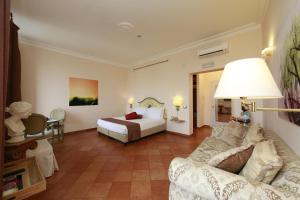 a hotel room with a bed and a couch at Residenza Gens Julia in Rome