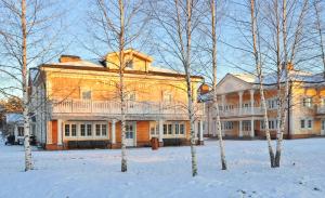 un gran edificio en la nieve con árboles delante en Hotel Yamskaya, en Zavidovo