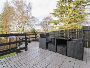 a patio with two chairs and a fence at The White House in Clitheroe