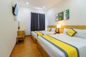 Giường trong phòng chung tại Hanah Hotel