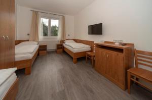 Postel nebo postele na pokoji v ubytování Hotel Panský dům
