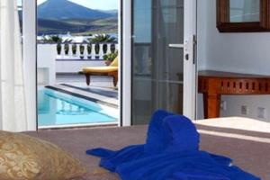 a blue towel on the floor in front of a house at Villas del Mar. Viña y Cabrera in Puerto Calero