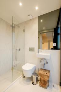 a bathroom with a toilet and a shower and a sink at BOUTIQUE Rentals- ATTICO Luxury Design-Ocean views in Porto +37 photos