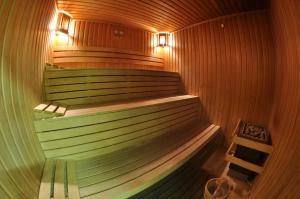 a sauna with a bench and two lights in it at Rhodopi Home Hotel Chepelare - Half board in Chepelare