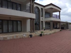 a large building with a brick driveway in front of it at Winchester Place in Port Elizabeth