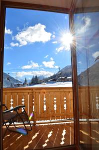 a view from a window of a deck with snow at Hotel Starjet in Flachau