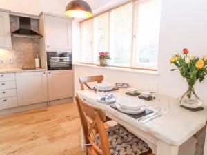 a kitchen and dining room with a table and chairs at The Duck House in Thetford