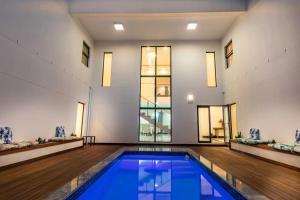 a swimming pool in a large room with a large window at Oceanway Boutique Hotel/Conference in Cape Town