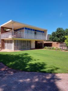 a large building with a large lawn in front of it at Goedgedacht Guestrooms in Potchefstroom