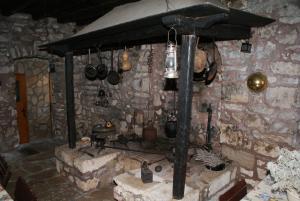 a kitchen with a stone wall with a stove at Apartments Kaštel in Ložišće