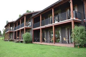 a large building with a lawn in front of it at Terra Newen Pucon Family Suites in Pucón