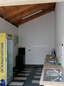 a kitchen with a row of sinks in a room at Camping Weides in Küps