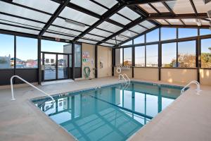 a swimming pool with a view of a building at Brighton Suites Hotel in Rehoboth Beach