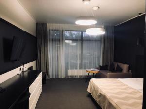 ヴィーシュホロドにあるSobi Hotelのベッドとソファ付きのホテルルーム
