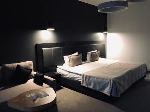 a bedroom with a large bed and a table at Sobi Hotel in Vyshhorod