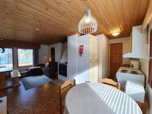 a kitchen and living room with a white refrigerator at Camping Hossan Lumo in Hossa