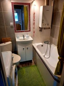 a bathroom with a sink and a tub and a toilet at Modern Studio 9 in Częstochowa