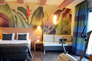 a hotel room with a bed and a scooter at Relais Bellaria Hotel & Congressi in Bologna