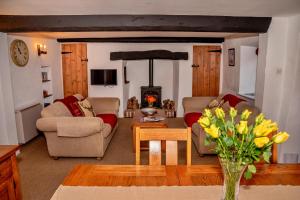 a living room with two couches and a fireplace at Finest Retreats - Little Haven in Minehead