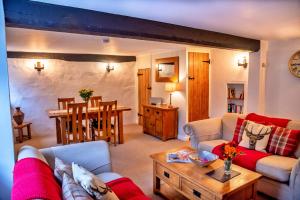 a living room with a couch and a table at Finest Retreats - Little Haven in Minehead