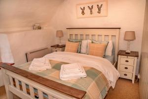 a bedroom with a large bed with two night stands at Finest Retreats - Little Haven in Minehead