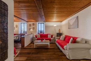 uma sala de estar com sofás vermelhos e uma mesa em Hotel Signal em Macugnaga